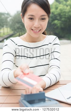 Woman using credit crad to pay