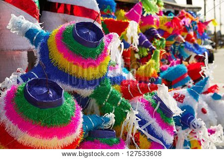 Mexican party pinatas decorated with fringed tissue colorful paper