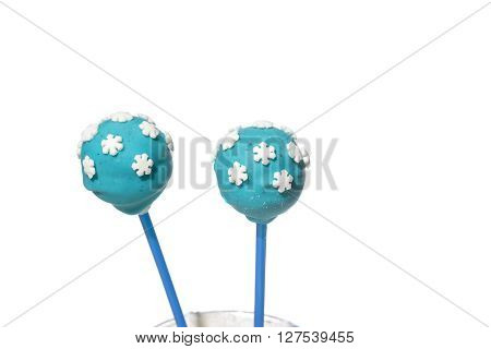 Two blue cakepops with snowflakes decorations on isolated background