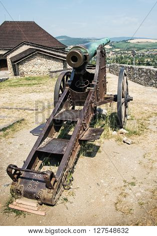 Rusty historic cannon in Trencin castle Slovak republic. Weapons theme. Historical military theme.