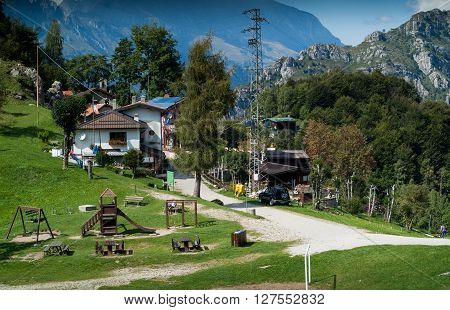 Piani d'Erna Italy - September 7th 2015: a group of countryside houses and a wooden playground photographed at Piani d'Erna (part of the Alps) near Lake Como in Italy
