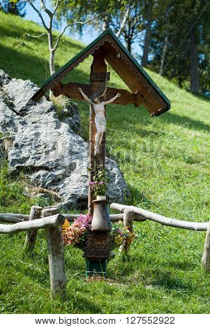 a wooden cross with a figure of Jesus photographed at Piani d'Erna in Italy