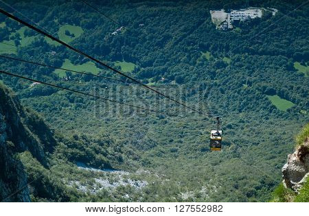 Piani d'Erna Italy - September 7th 2015: a yellow cable car carrying passengers down from Piani d'Erna (part of the Italian Alps)