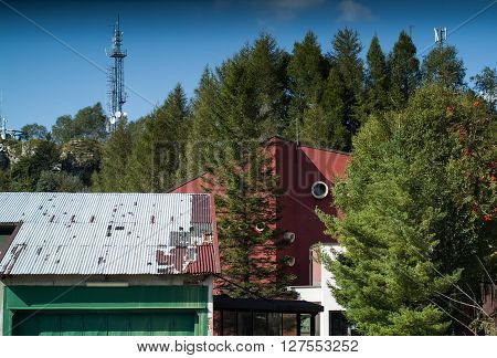 a cable car station hiding behind trees at Piani d'Erna (part of the Italian Alps)