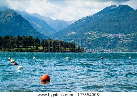 colorful buoys floating on Lake Como photographed from the area near Colico a town in north Italy