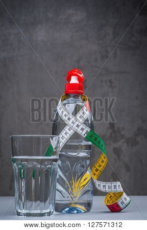 Bottle Of Fresh Still Water With Measuring Tape
