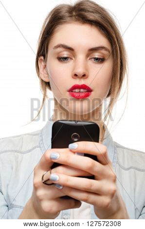 Beautiful Young Woman Chatting Sms Or Serfing The Internet By Mobile Phone, On A White Background