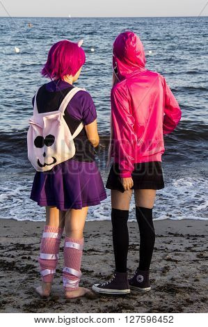 QUARTU S.E., ITALY - August 2, 2015: Beach Cosplay Party - costume parade held at the Marlin Club of Poetto Beach - Sardinia - Group of kids cosplay costume watching the reflections of the sea