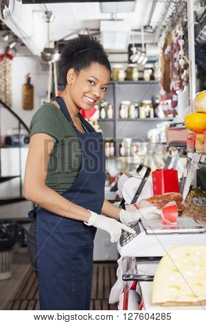 Happy Saleswoman Weighting Cheese On Weight Scale