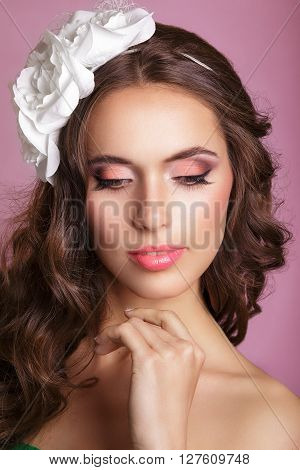 Portrait of a beautiful woman in a wedding dress in the image of the bride. Picture taken in the studio. Portrait of beautiful bride. Wedding dress. Wedding decoration