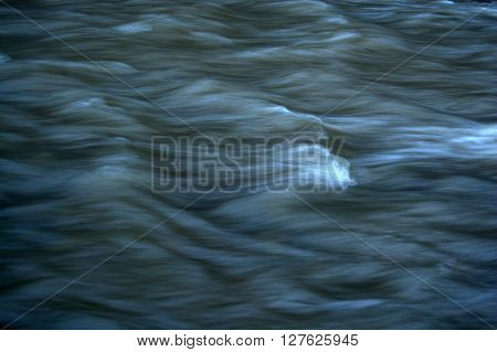 Turbid River Flow. Cold Spring Stream. Muddy water.