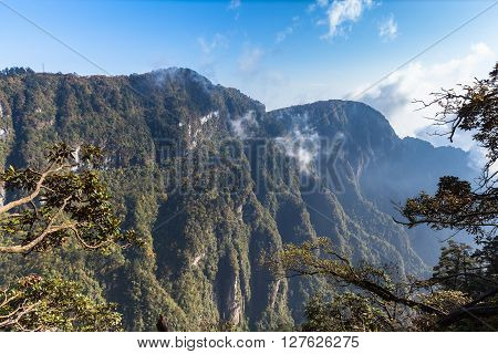 Beautiful View on the Emei mountain in the morning with sunlight and mist. It is a famous buddhist moutain located near Chengdu Sichuan Province China