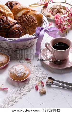 Coffee and french pastry, sweet desserts for breakfast with spring tulip flowers, vintage porcelain cup. Lovely breakfast.