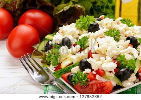 Vegetable salad with tomatoes, cucumbers, olives and feta cheese -bulgarian traditional summer salad.