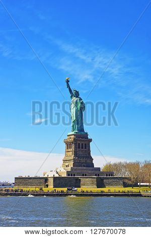Statue on Liberty Island New York City USA. In Upper New York Bay. Tourists are walking on the island.