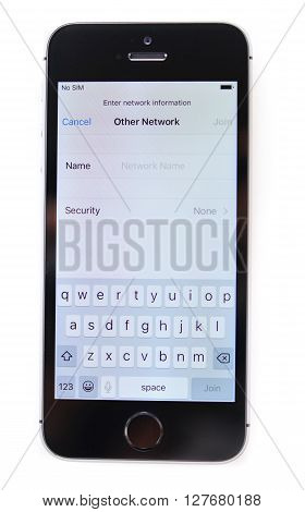 PARIS FRANCE - APR 21 2016: First start of the new iPhone SE with Wi-Fi-Settings on screen - the new phone combines the updated processor 4K rear camera touch id retina display