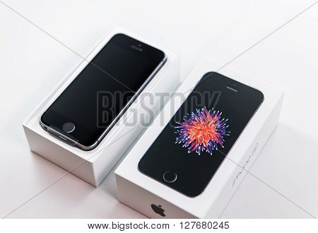PARIS FRANCE - APR 21 2016: Unboxing of the new Apple iPhone SE combining the updated processor 4K rear camera touch id retina display