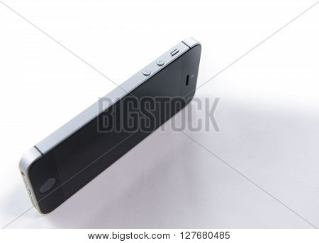 PARIS FRANCE - APR 21 2016: Side view of the new Apple iPhone SE combining the updated processor 4K rear camera touch id retina display