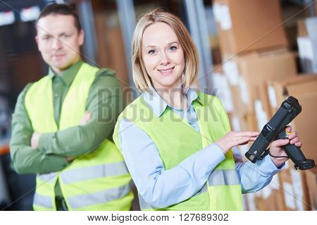 Warehouse Management System. Worker with barcode scanner