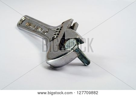 Adjustable Wrench And Bolt On White Background