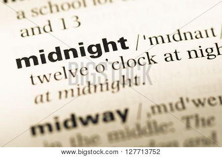 Close Up Of Old English Dictionary Page With Word Midnight.