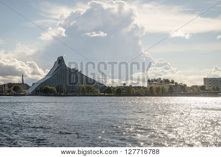 RIGA, LATVIA - JULY 20: Modern building of national library in Riga Latvia at waterfront against of cloudy sky. July 2015