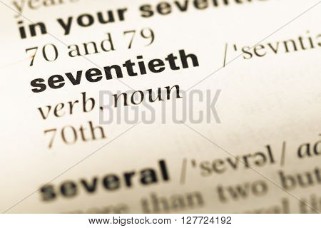Close Up Of Old English Dictionary Page With Word Seventieth.