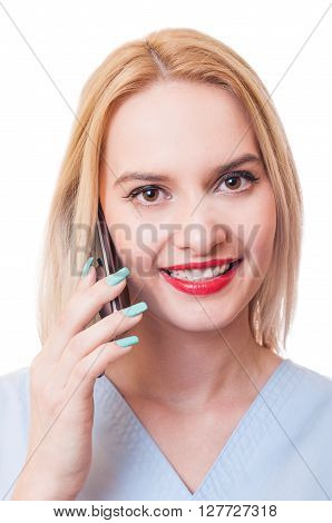 Smiling woman doctor talks on smartphone. Contactus concept on white background.