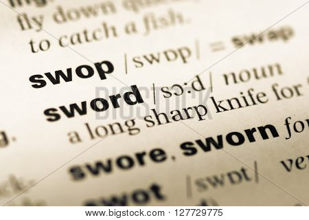 Close Up Of Old English Dictionary Page With Word Swop.