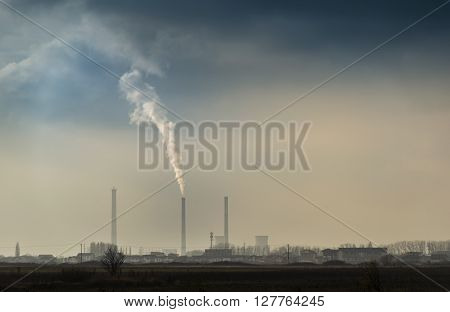 Industrial cityscape with coal power plant and smoke stacks