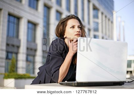 Beautyful woman student working outside with laptop