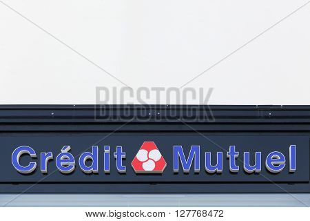 Macon, France - March 22, 2016: Credit Mutuel logo on a wall. Credit Mutuel is a major French bank, with headquarters in Strasbourg, France