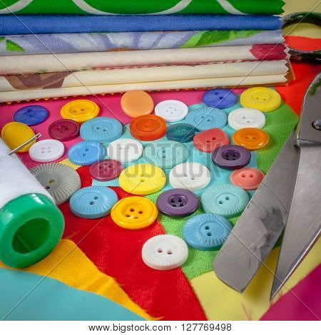 background with sewing accessories, with colored chintz, buttons, shears, set for needlework
