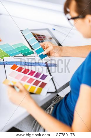 interior design and renovation concept - woman working with color samples for selection