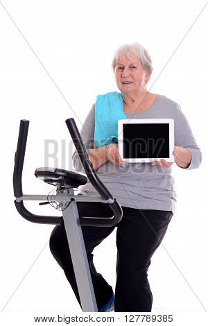 Female Senior Train With Fitness Machine And Showing Tablet Pc