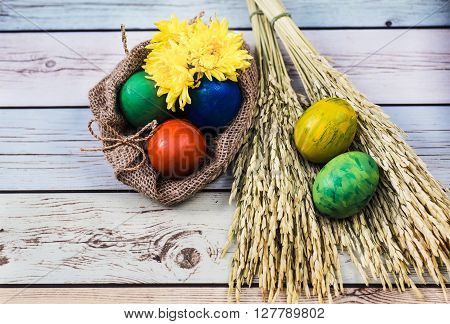 Easter morning: eggs  and yellow flowers on wood background