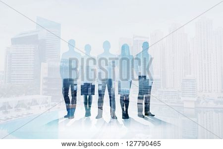 business, teamwork and people concept - business people silhouettes over city background with double exposure effect