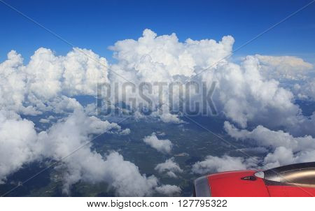 aerial top view from air plane see green field rural and wing aircraft engine clear white cumulus cloud and cloudscape on blue sky