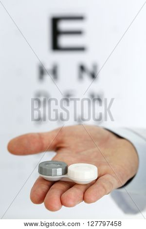 Male Doctor Hands Giving Pair Of Contact Lens