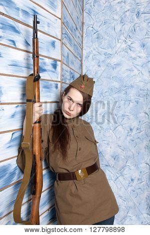 Woman in Russian military uniform with rifle. Female soldier during the second world war.
