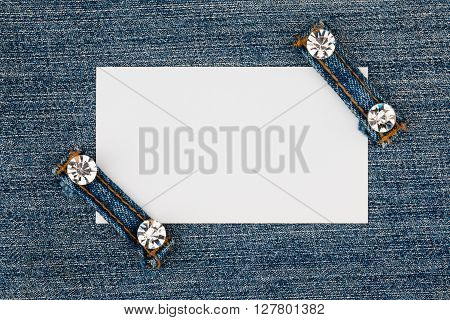 Business card with two straps jeans lies on the light denim with space for your text
