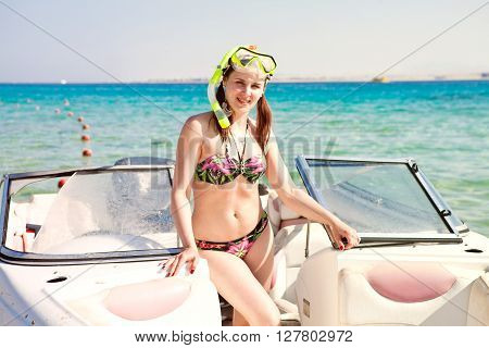 happy young girl enjoys summer vacation in ocean cruise on powerboat