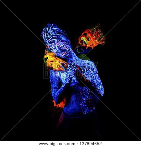 Fire and Air. Body art glowing in ultraviolet light, four elements, isolated on black background
