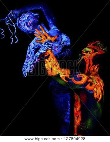 Fire and Air. Body art glowing in ultraviolet light, four elements, isolated on black background