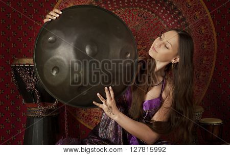 Young Caucasian woman with hand pan indoors