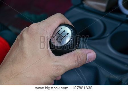 Left Hand Holding A Gear Shift Lever