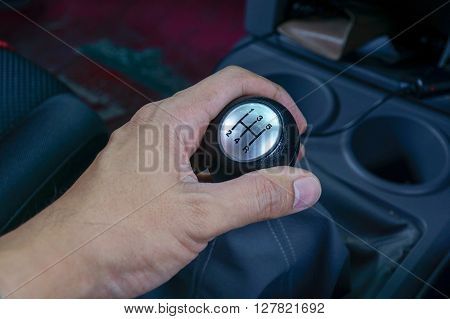 Left Hand Holding A Gear Shift Lever
