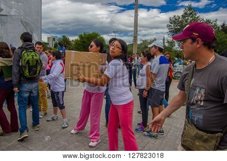 Quito, Ecuador - April, 17, 2016: Unidentified citizens of Quito providing disaster relief food, clothes, medicine and water for earthquake survivors in the coast.