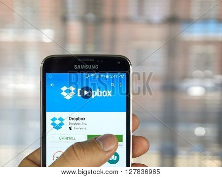MONTREAL CANADA - APRIL 7 2016 : Dropbox application on a cell phone. Dropbox is a file hosting service operated by Dropbox Inc.