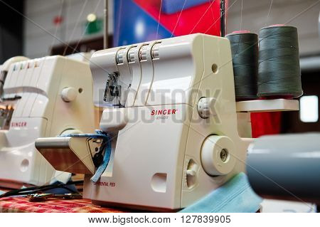 STRASBOURG FRANCE - APR 24 2016: Singer sewing machines at traditional textile covered market with multiple different colors and textures